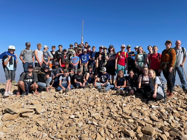 Students and staff posing at the summit of Mt. Loafer