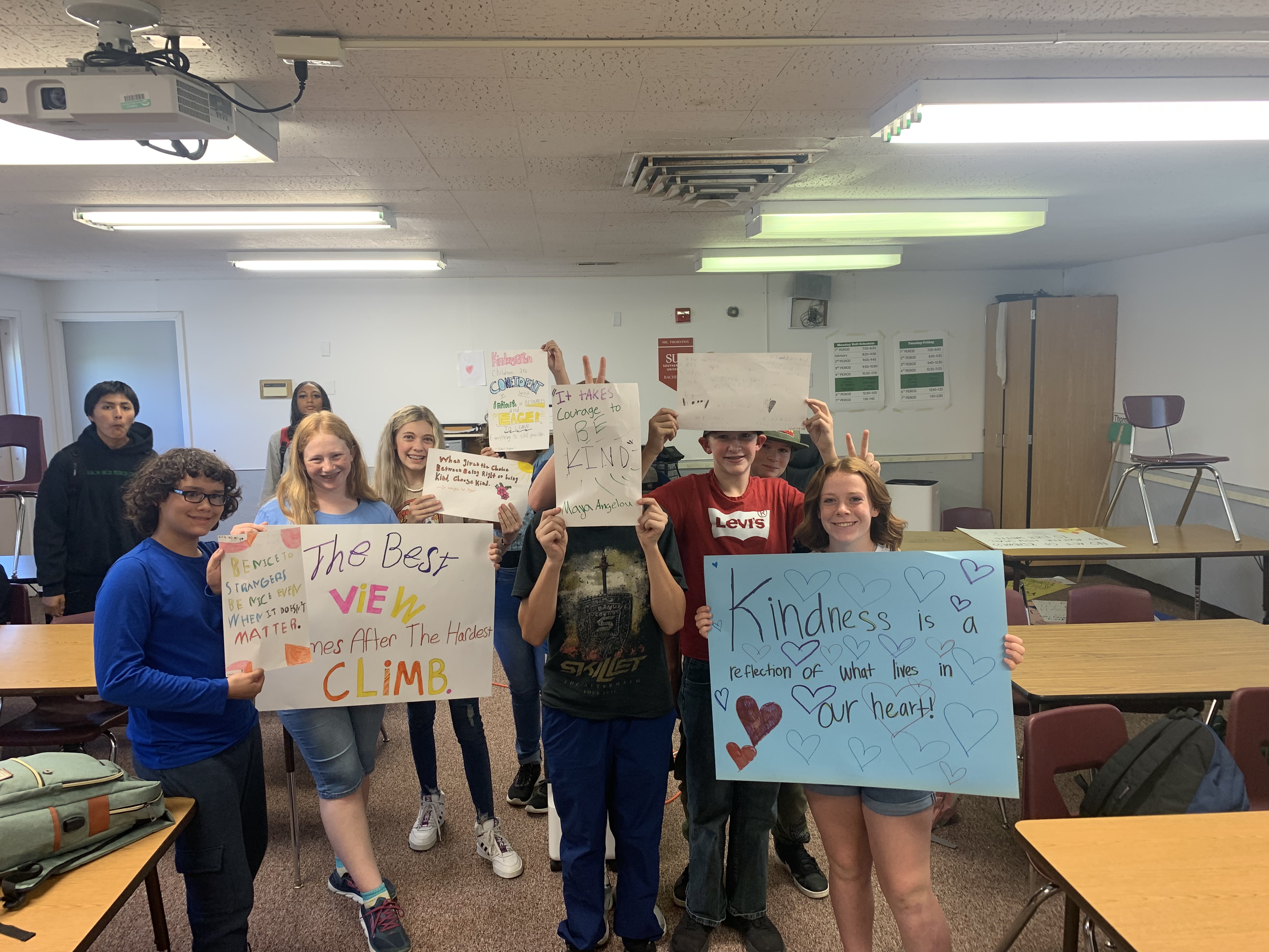 Students holding kindness posters