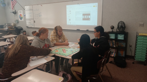 Students playing social studies Monopoly