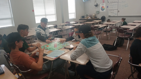 Students playing social studies Monopoly