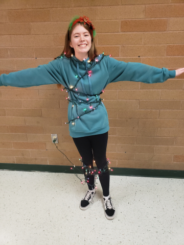 Student wearing Christmas tree lights