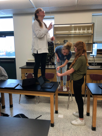 Mr. Gowans' students testing mass and velocity with marbles